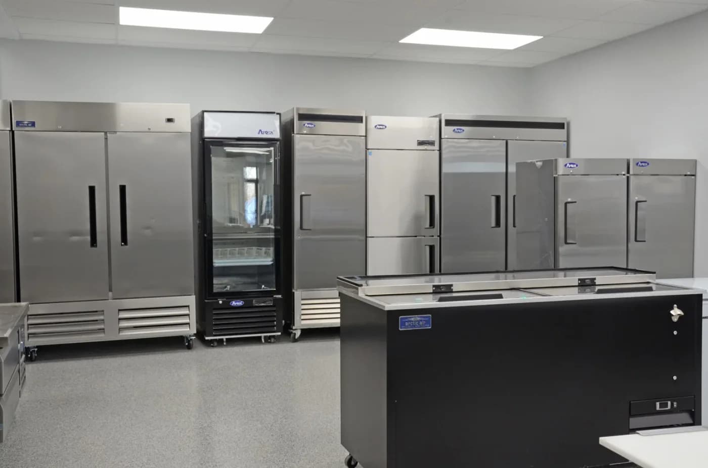 Commercial reach-in refrigerators and freezers in an equipment room