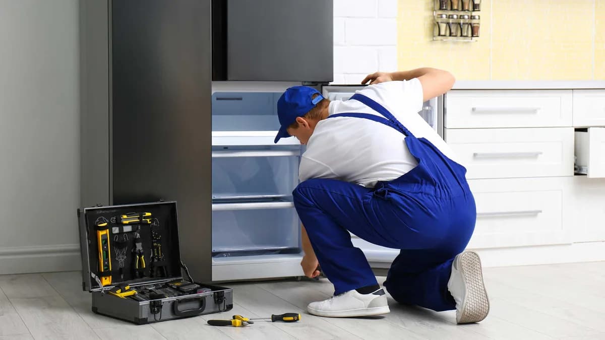 Technician inspecting an open freezer compartment
