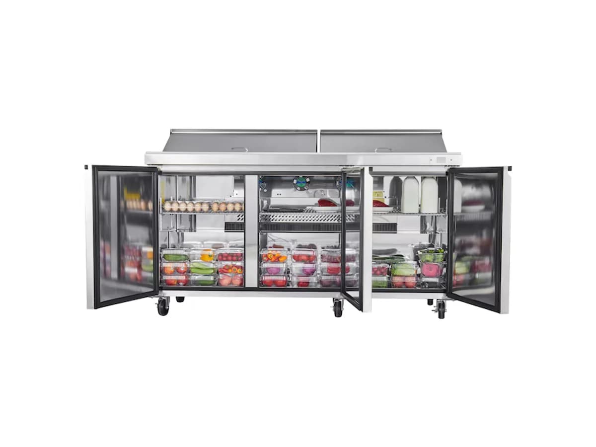 Open refrigerated prep table with stocked drawers and doors
