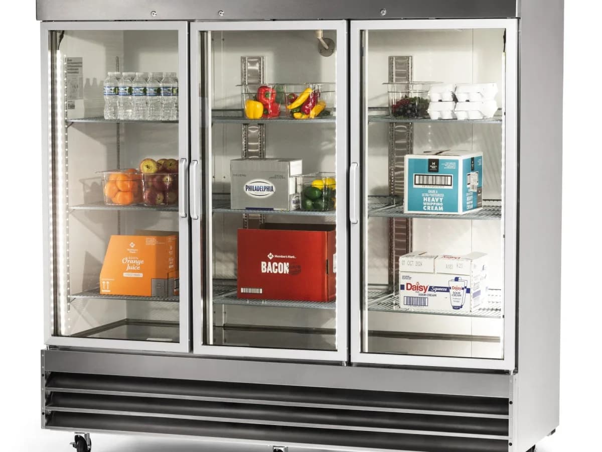 Three-door reach-in refrigerator with glass doors and stocked shelves